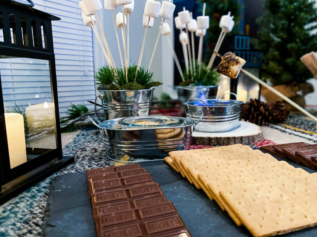 A great idea on how to make s'mores without a fire, just use sterno 20261 s'mores heat can, we placed in on a s'mores bar with Hershey's chocolate, graham crackers, marshmallows on sticks, and a black lantern. National S'mores Day.