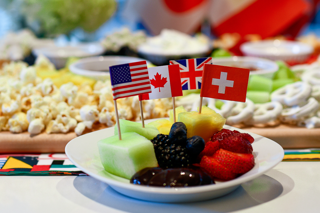 Guests will love these cute world flag picks as they eat our Olympic ring charcuterie board, which features fruit in the shape of the Olympic rings. Olympic Party Ideas, Olympic decorations, Olympic party