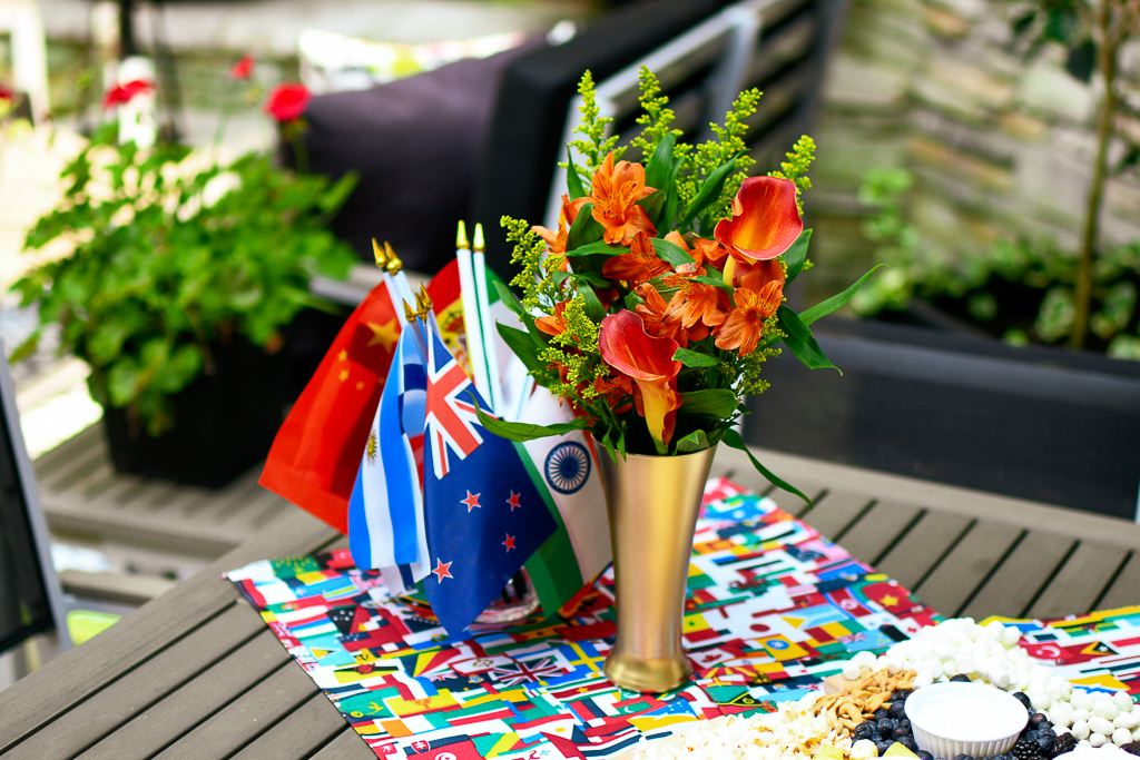 With just a little effort, we transformed plain old pilsner glasses into Olympic torch vases. By keeping the floral color palette in the orange tones with yellow accents, the result is sophisticated, stunning and reminiscent of the Olympic flame.