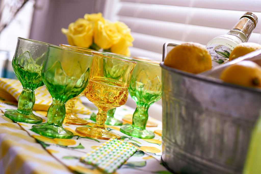 Green vintage glassware, yellow vintage glassware, lemon table runner, yellow and white checked tablecloth, galvanized pail with lemons, all great summer party themes and lemon party theme ideas. It's also cute lemonade stand ideas with lemonade cocktail recipes, as party of a lemonade party idea, event planning, home decor, vintage glassware, vintage green glassware, vintage yellow glassware, lemon table runner, lemon theme decor, lemon theme party ideas, lemonade cocktail recipes