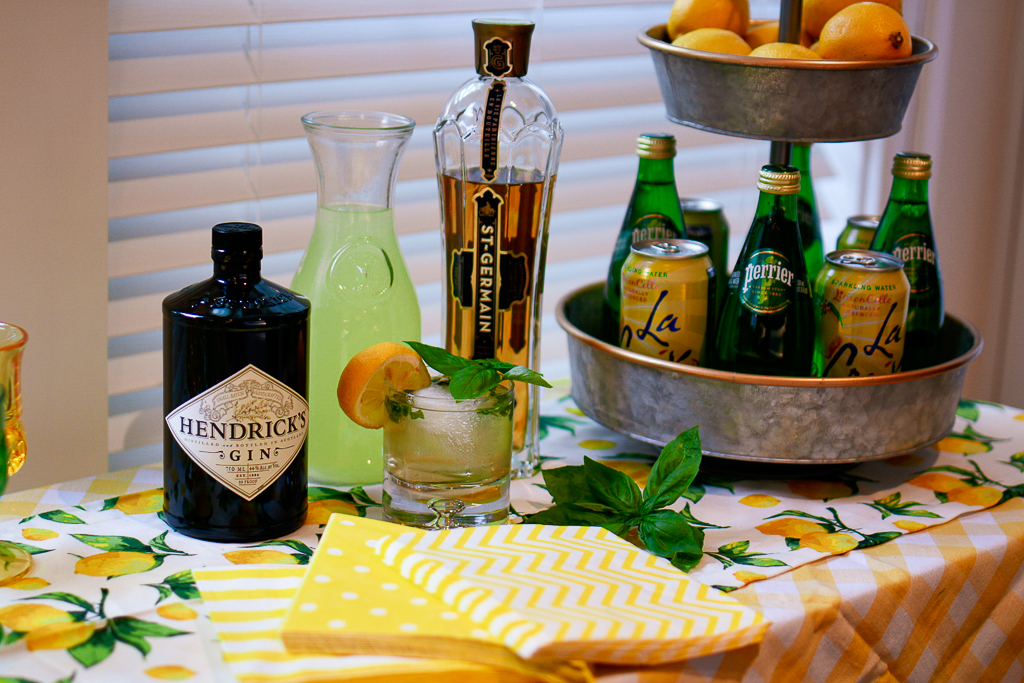 best alcohol to mix with lemonade, lemonade cocktail recipes, lemonade cocktails, gin lemonade cocktail recipes, galvanized tiered stand with lemons, lemon table runner, yellow and white check tablecloth, striped yellow napkins, yellow polka dot napkin, hendrick's gin recipe, St. Germain recipe, lemon theme decor, lemon theme party ideas, lemonade party ideas