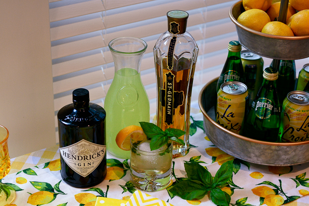 best alcohol to mix with lemonade, lemonade cocktail recipes, lemonade cocktails, gin lemonade cocktail recipes, galvanized tiered stand with lemons, lemon table runner, yellow and white check tablecloth, striped yellow napkins, yellow polka dot napkin, hendrick's gin recipe, St. Germain recipe, lemon theme decor, lemon theme party ideas, lemonade party ideas