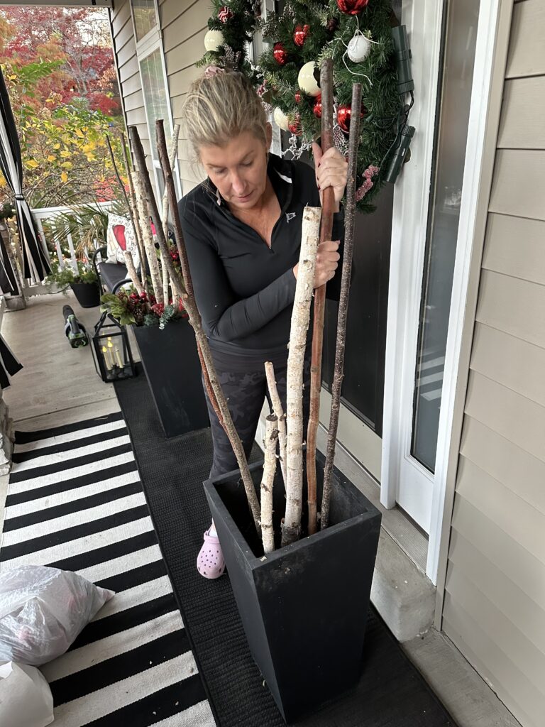 Christmas outdoor planter ideas, DIY Christmas outdoor planter, Christmas planter with birch branches, Outdoor holiday planter tutorial, Winter porch planter ideas, how to make a Christmas planter, birch branch Christmas arrangement, holiday planter with ornaments, outdoor Christmas decor ideas, DIY holiday planter with lights, winter outdoor arrangement, battery operated fairy lights outdoor, festive front porch décor, holiday urn planter ideas, Christmas container gardening