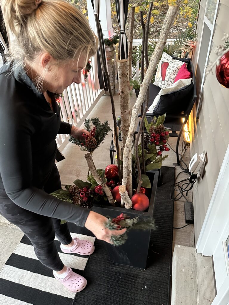 Christmas outdoor planter ideas, DIY Christmas outdoor planter, Christmas planter with birch branches, Outdoor holiday planter tutorial, Winter porch planter ideas, how to make a Christmas planter, birch branch Christmas arrangement, holiday planter with ornaments, outdoor Christmas decor ideas, DIY holiday planter with lights, winter outdoor arrangement, battery operated fairy lights outdoor, festive front porch décor, holiday urn planter ideas, Christmas container gardening