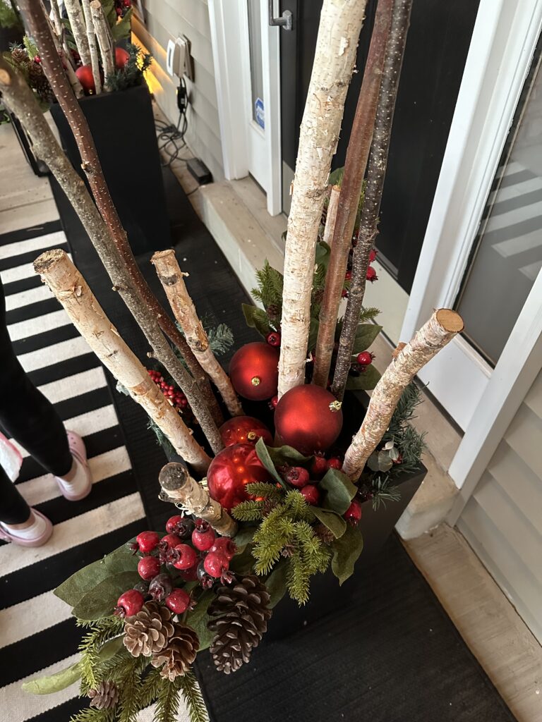 Christmas outdoor planter ideas, DIY Christmas outdoor planter, Christmas planter with birch branches, Outdoor holiday planter tutorial, Winter porch planter ideas, how to make a Christmas planter, birch branch Christmas arrangement, holiday planter with ornaments, outdoor Christmas decor ideas, DIY holiday planter with lights, winter outdoor arrangement, battery operated fairy lights outdoor, festive front porch décor, holiday urn planter ideas, Christmas container gardening