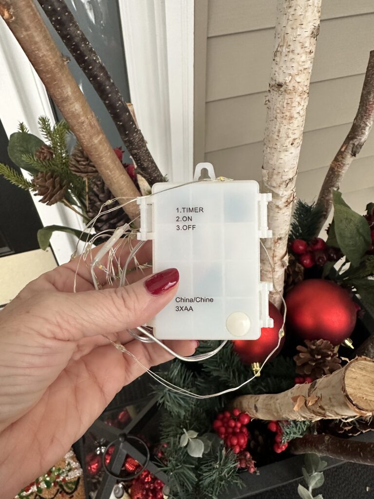 Christmas outdoor planter ideas, DIY Christmas outdoor planter, Christmas planter with birch branches, Outdoor holiday planter tutorial, Winter porch planter ideas, how to make a Christmas planter, birch branch Christmas arrangement, holiday planter with ornaments, outdoor Christmas decor ideas, DIY holiday planter with lights, winter outdoor arrangement, battery operated fairy lights outdoor, festive front porch décor, holiday urn planter ideas, Christmas container gardening