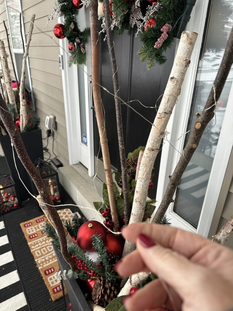  Christmas outdoor planter ideas, DIY Christmas outdoor planter, Christmas planter with birch branches, Outdoor holiday planter tutorial, Winter porch planter ideas, how to make a Christmas planter, birch branch Christmas arrangement, holiday planter with ornaments, outdoor Christmas decor ideas, DIY holiday planter with lights, winter outdoor arrangement, battery operated fairy lights outdoor, festive front porch décor, holiday urn planter ideas, Christmas container gardening