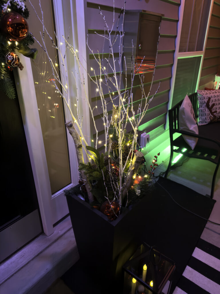 Christmas outdoor planter ideas, DIY Christmas outdoor planter, Christmas planter with birch branches, Outdoor holiday planter tutorial, Winter porch planter ideas, how to make a Christmas planter, birch branch Christmas arrangement, holiday planter with ornaments, outdoor Christmas decor ideas, DIY holiday planter with lights, winter outdoor arrangement, battery operated fairy lights outdoor, festive front porch décor, holiday urn planter ideas, Christmas container gardening